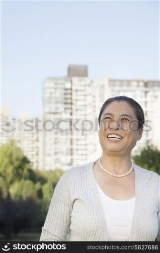 Mature woman looking at the sky, portrait