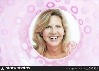 Mature woman looking through an inflatable ring