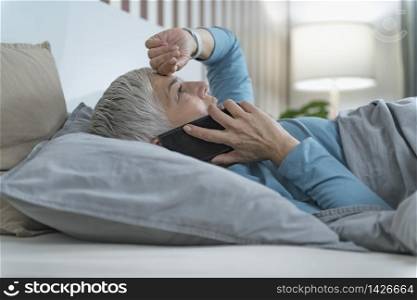 Mature Woman Lying in Bed, Talking Over the Phone