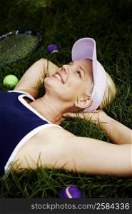 Mature woman lying on the grass and smiling
