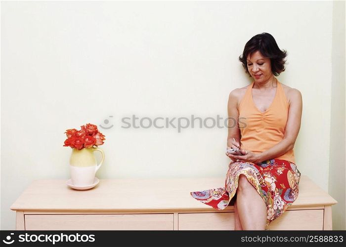 Mature woman operating a personal data assistant