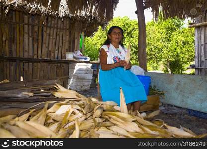 Mature woman peeling corn, Papantla, Veracruz, Mexico