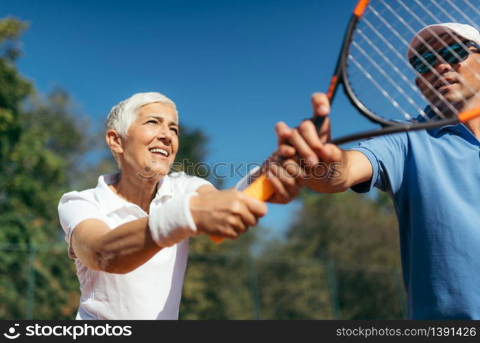 Mature Woman Playing Tennis