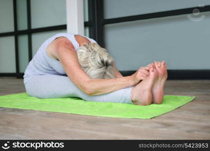 Mature woman practicing yoga