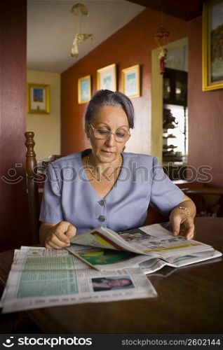 Mature woman reading a newspaper