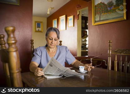 Mature woman reading a newspaper