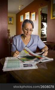 Mature woman reading a newspaper