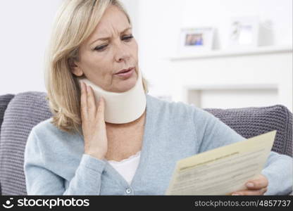 Mature Woman Reading Letter After Receiving Neck Injury