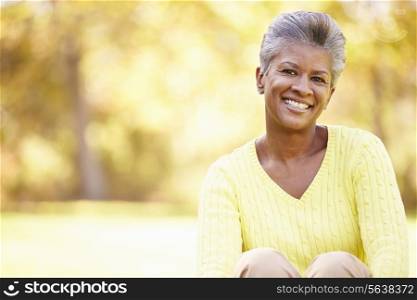 Mature Woman Relaxing In Autumn Landscape