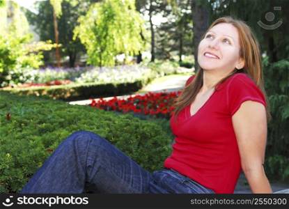 Mature woman relaxing outside in summer park