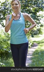 Mature Woman Running Outdoors In Countryside