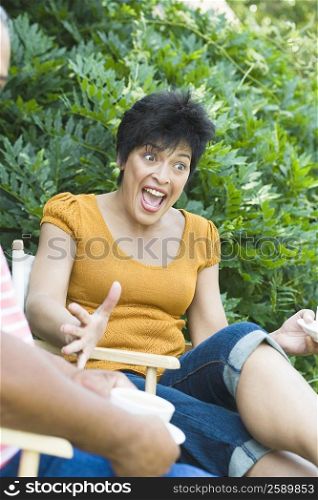 Mature woman sitting on a chair and shouting