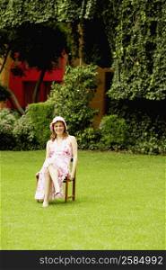Mature woman sitting on a chair in a lawn