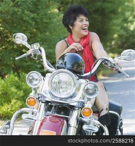 Mature woman sitting on a motorcycle and smiling