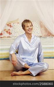 Mature woman sitting on the floor and smiling