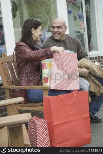 Mature woman sitting with a mid adult man and smiling
