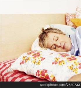 Mature woman sleeping on the bed