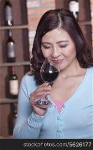 Mature Woman Smelling a Glass of Wine