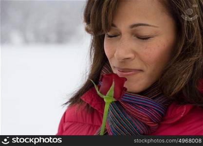 Mature woman smelling a rose