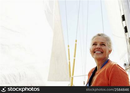Mature woman smiling in a sailboat