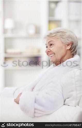 Mature woman smiling in a white coat