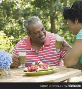 Mature woman smiling with a senior man at the breakfast table