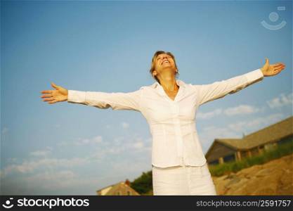 Mature woman smiling with her arms outstretched