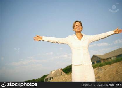 Mature woman smiling with her arms outstretched