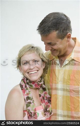 Mature woman smiling with her husband looking at her