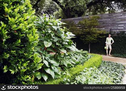 Mature woman standing in a garden