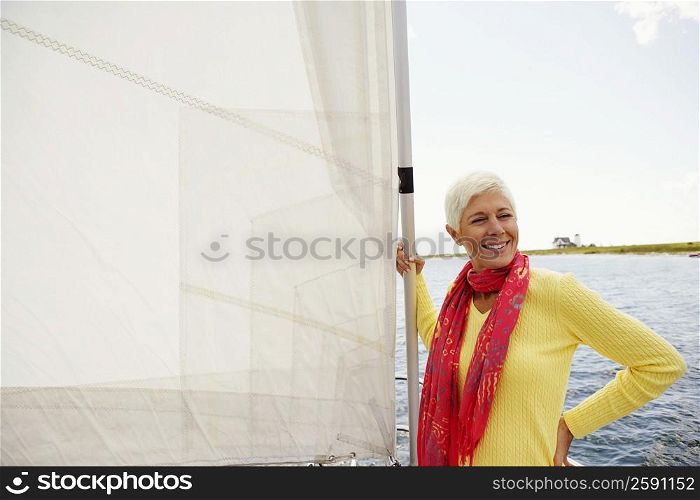 Mature woman standing in a sailboat and smiling