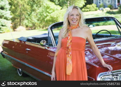 Mature woman standing near a car