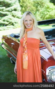 Mature woman standing near a car