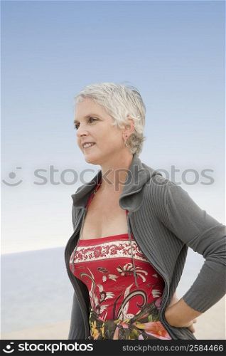 Mature woman standing on the beach