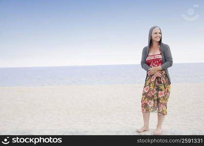 Mature woman standing on the beach