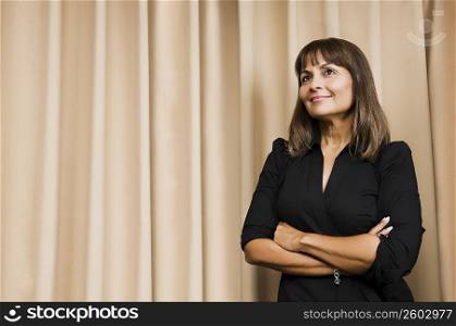 Mature woman standing with her arms crossed and smiling
