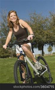 Mature woman stands with mountain bike