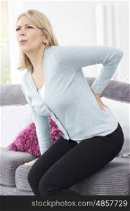 Mature Woman Suffering From Backache At Home