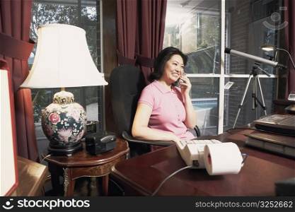 Mature woman talking on a cordless telephone