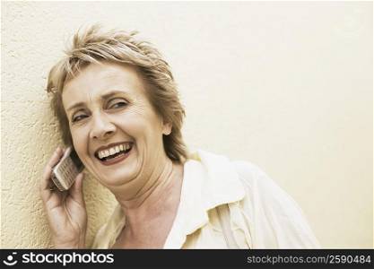 Mature woman talking on a mobile phone and smiling
