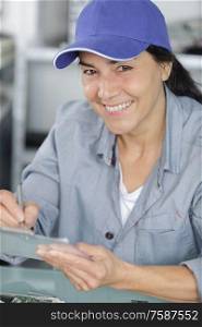 mature woman technician servicing at work on electric room
