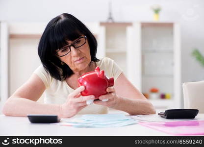 Mature woman trying to reconcile her bills