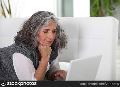 mature woman typing on her laptop