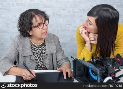 mature woman video editor and young assistant