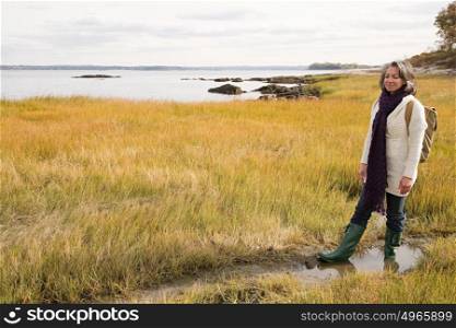 Mature woman walking on marshland