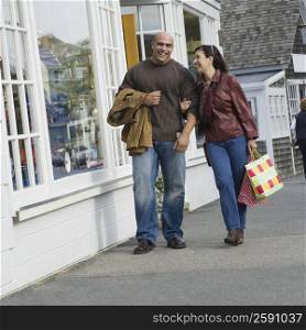 Mature woman walking with a mid adult man and smiling