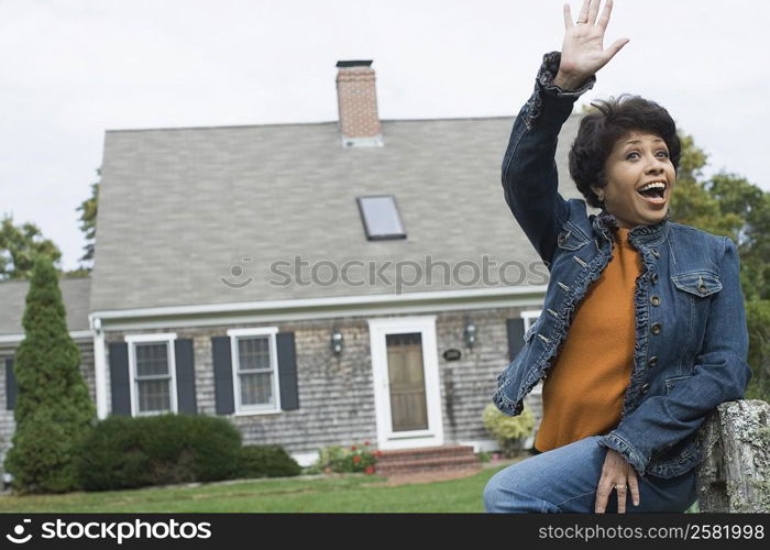 Mature woman waving her hand and smiling