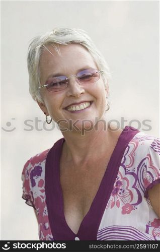 Mature woman wearing sunglasses and smiling