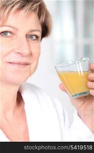Mature woman with a glass of orange juice