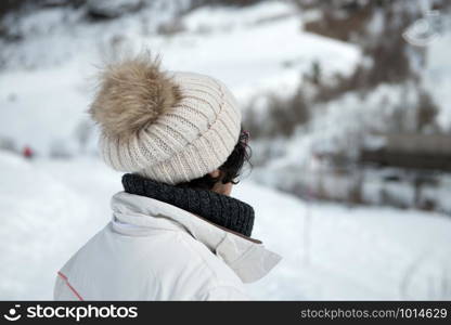 mature woman with a winter cap in the mountain